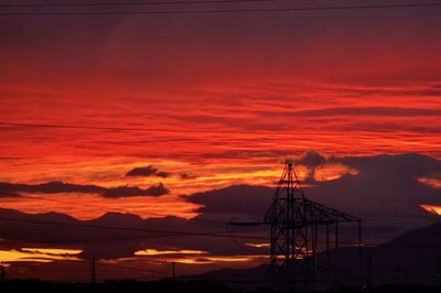 Low angle view of silhouette mountain against orange sky