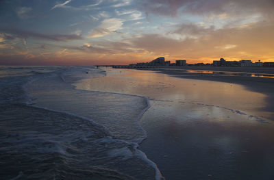 Scenic view of beach against sky during sunset