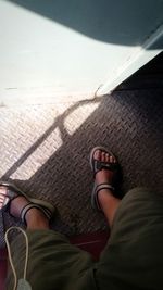 Low section of person standing on tiled floor