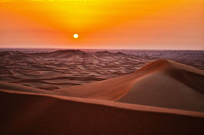 Scenic view of desert against dramatic sky