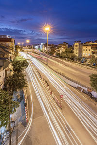 High angle view of light trails on road in city