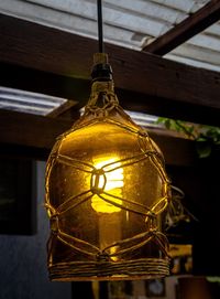 Low angle view of illuminated light bulb on table