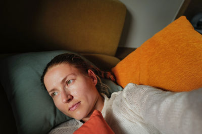 Woman relaxing on the colorful pillows