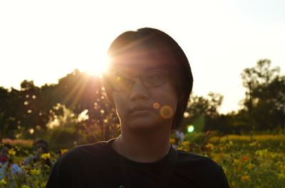 Portrait of young man against sky during sunset