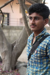Portrait of young man standing outdoors