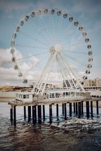 View of ferris wheel in sea