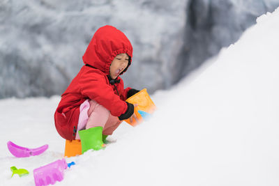 Low angle view of woman standing on snow