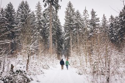 Woman standing on snow covered landscape