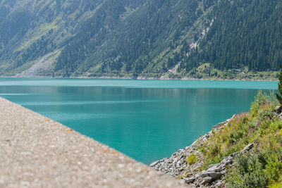 Scenic view of lake by mountains against sky