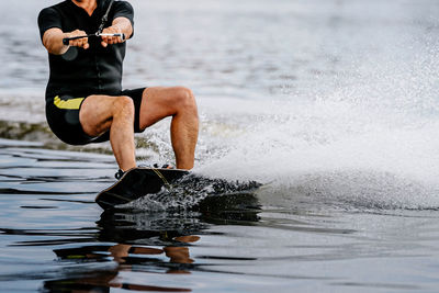 Shirtless man swimming in sea