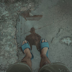 Low section of man standing in water