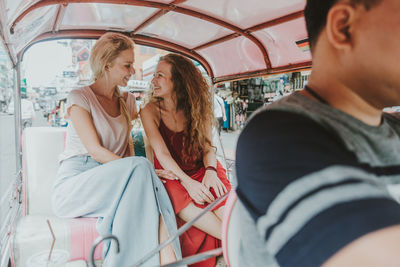 Women in jinrikisha on street