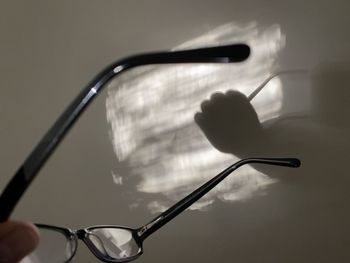 Close-up of hand holding eyeglasses