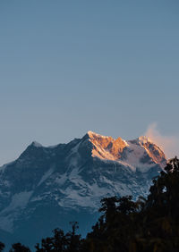 Scenic view of snowcapped mountains against clear sky