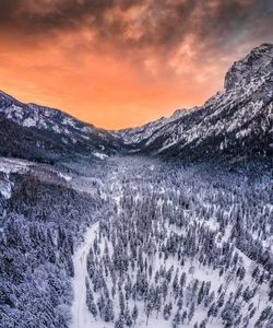 Scenic view of snowcapped mountains against sky during sunset