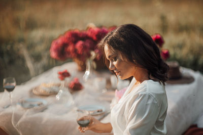 Woman sitting on table