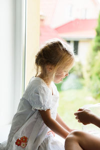 Little girl playing by the window