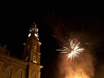 Low angle view of firework display at night