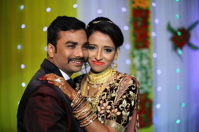 Smiling bridal couple posing on stage during wedding ceremony
