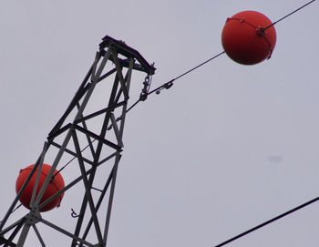 Low angle view of power lines against clear sky