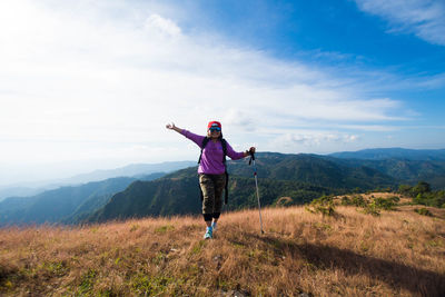 Full length of woman on mountain against sky