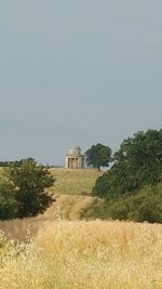 Built structure on field against clear sky