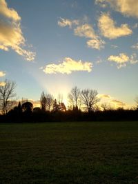 Scenic view of field against sky during sunset