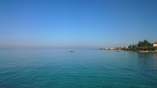 Scenic view of calm sea against clear sky