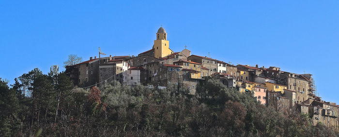 Low angle view of historic building against clear blue sky