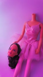 Beautiful young woman against pink background