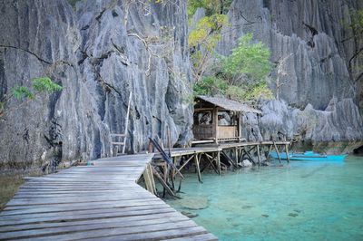 Boardwalk amidst lake and rocky mountains