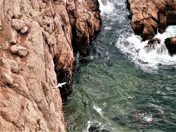 High angle view of rocks in sea