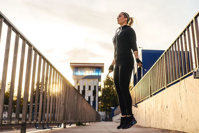 Full length of woman exercising in stadium