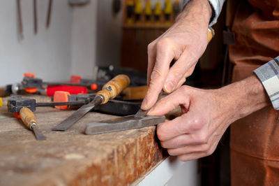 Midsection of man working at workshop