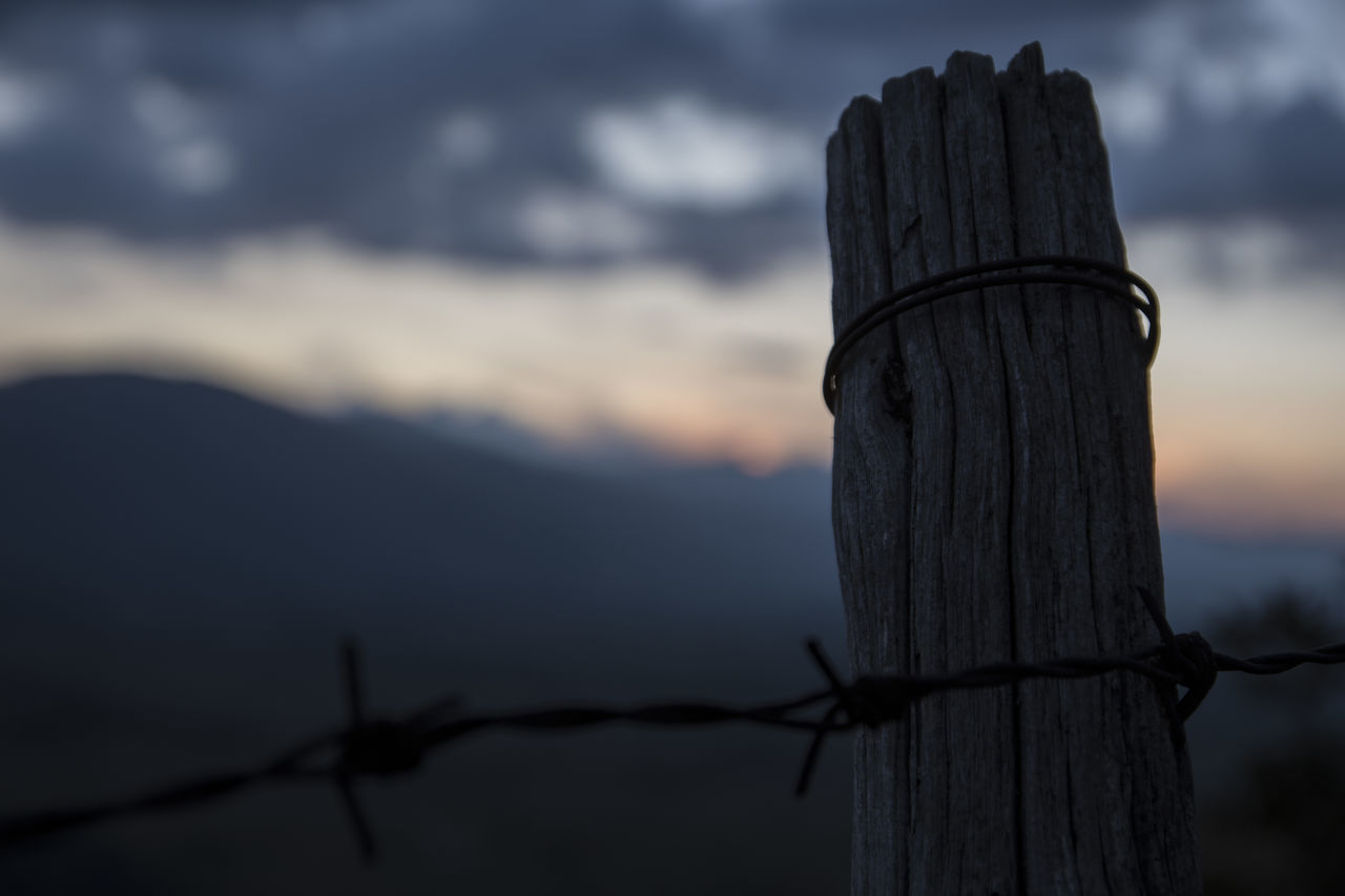 VIEW OF BARBED WIRE FENCE AGAINST SKY