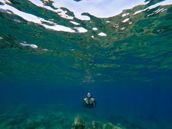 Woman swimming undersea