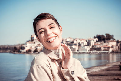 Woman with short hair is smiling and looking into the camera. copy space for your message.