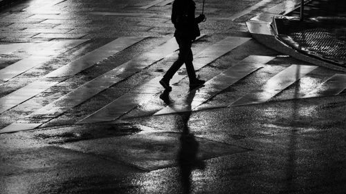 Low section of man walking on street