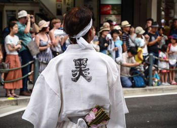 Rear view of people on street in city