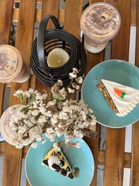 Coffees and pastries on a wooden cafe table