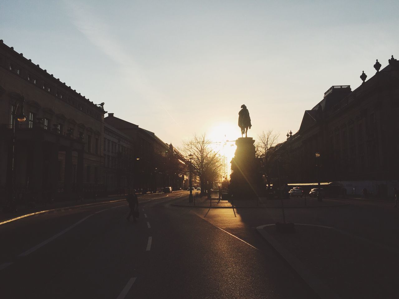 STREET AMIDST SILHOUETTE TREES AGAINST SKY