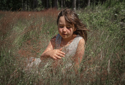 Woman looking away on field
