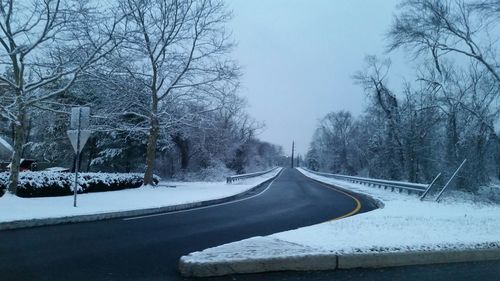 Road passing through snow covered landscape