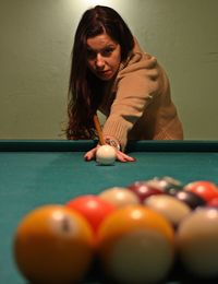Young woman playing snooker