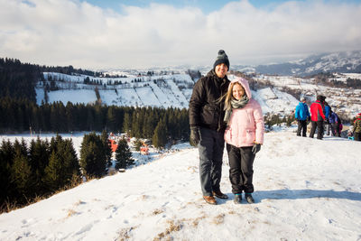 Full length of woman on snow covered mountains against sky