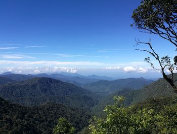 Scenic view of mountains against blue sky