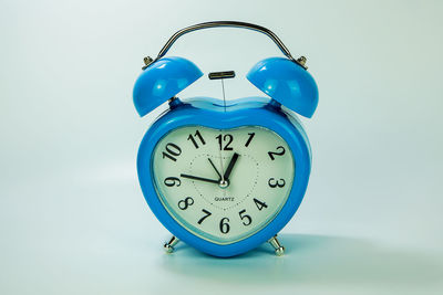 Close-up of clock against blue background