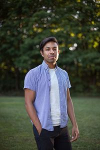 Mid adult man standing on grass