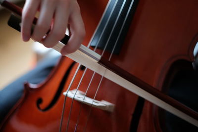 Cropped image of person playing cello