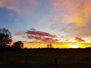 Scenic view of field against sky during sunset